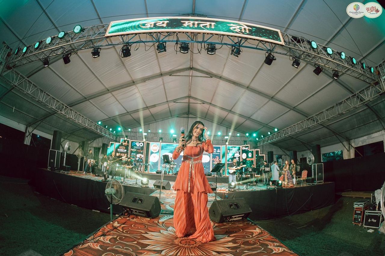 Singer performing live on stage at Surbhi Garba Dhoom Dandiya 2025, Chattarpur Farms, Nagpur