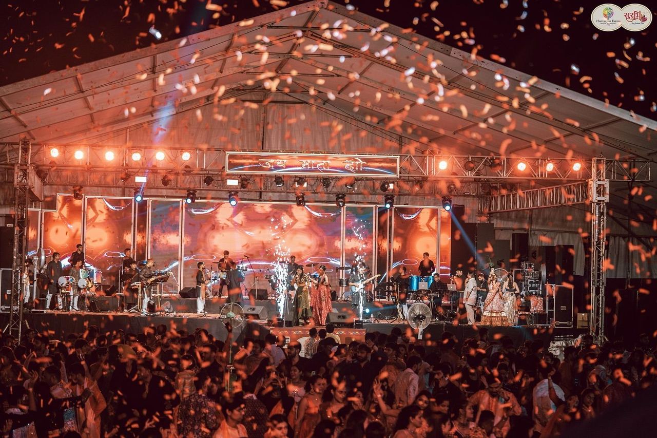 Confetti over the crowd and stage at Surbhi Garba Dhoom Dandiya 2025, Chattarpur Farms, Nagpur