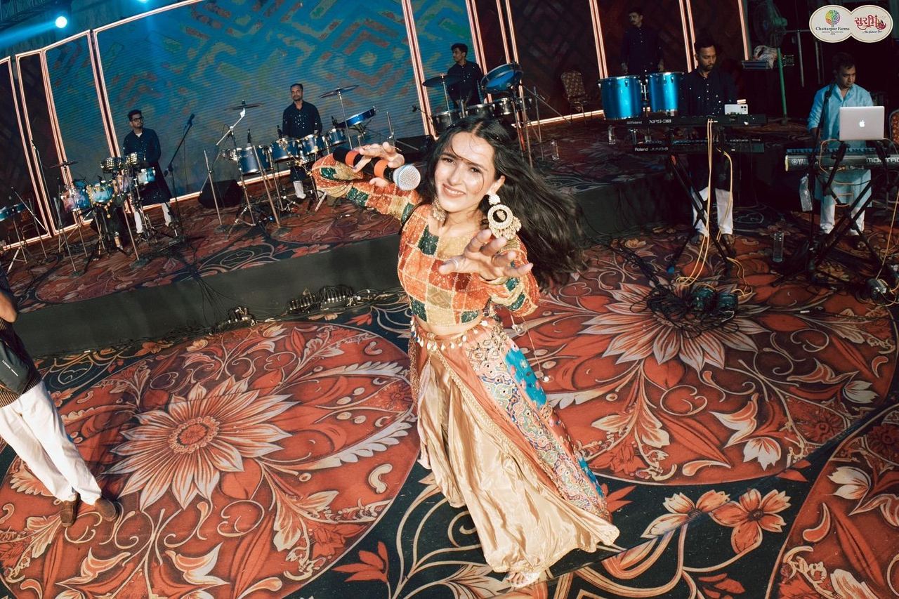 Dancer performing on the floral stage carpet at Surbhi Garba Dhoom Dandiya 2025, Chattarpur Farms, Nagpur