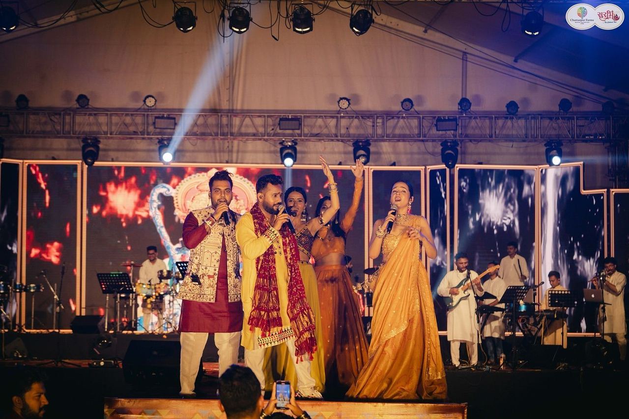 Singers performing together on stage at Surbhi Garba Dhoom Dandiya 2025, Chattarpur Farms, Nagpur