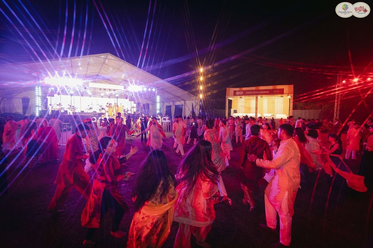 Dance floor with light beams at night, Surbhi Garba Dhoom Dandiya 2025, Chattarpur Farms, Nagpur