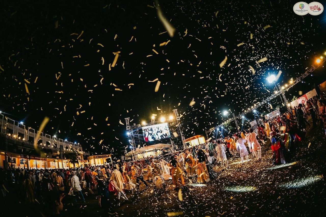 Golden confetti over the garba ground at night, Surbhi Garba Dhoom Dandiya 2025, Chattarpur Farms, Nagpur